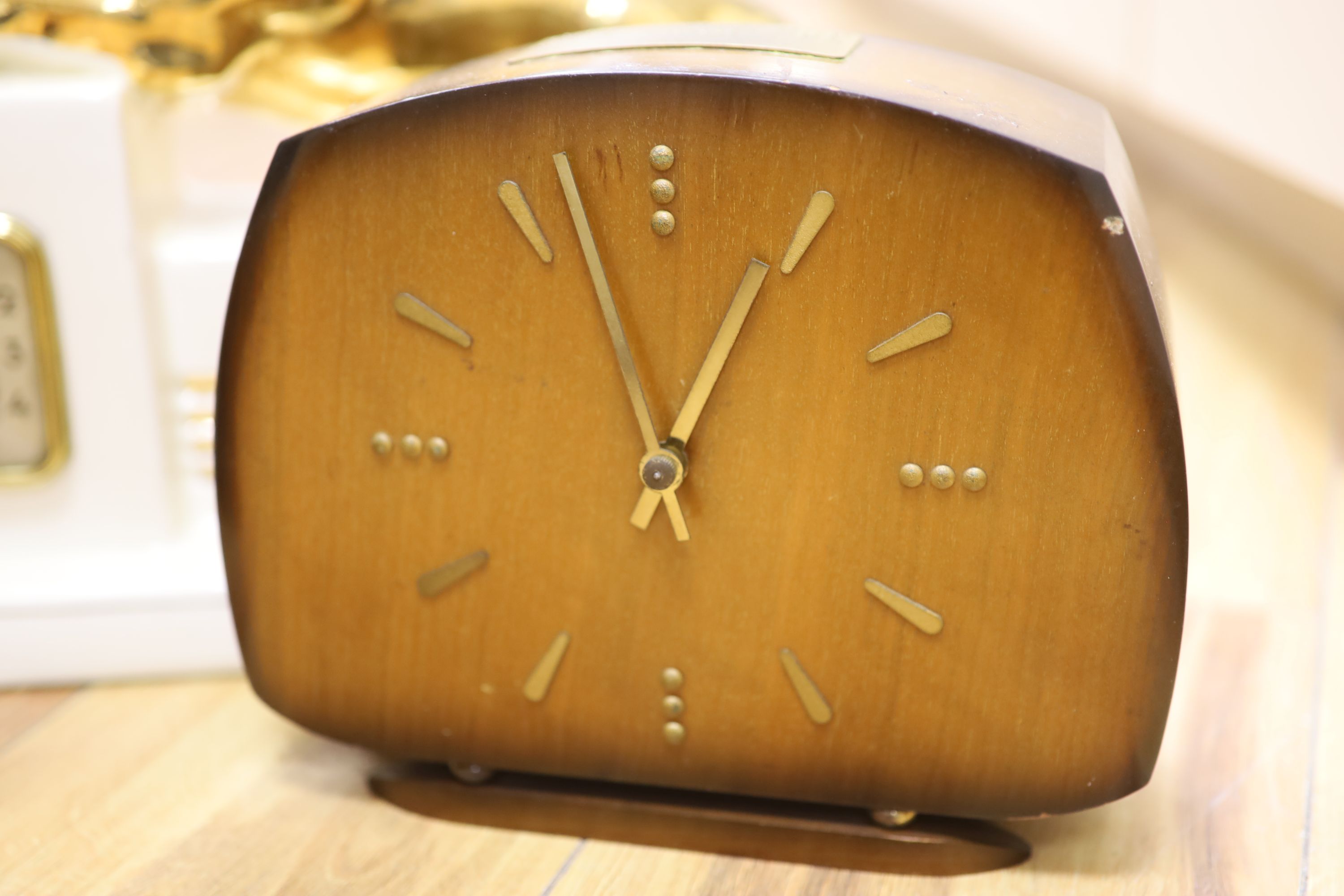 Two wooden Art Deco clocks and a ceramic clock modelled with lion cub